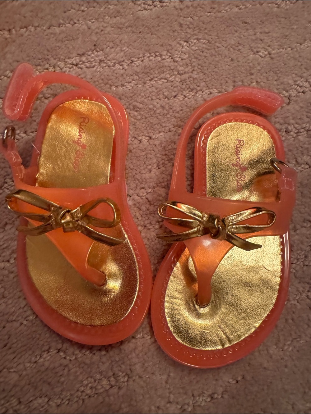 Rising Star Coral Jelly Sandals with Metallic Gold Bow Accent